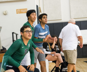 Juniors Dino Romeo, Anthony Gil, and Shayan Emtiaz watch anxiously during Nov. 5's girls' volleyball game against St. Margarets Episcopal School November 5, 2013. Photographer: Kellen Ochi