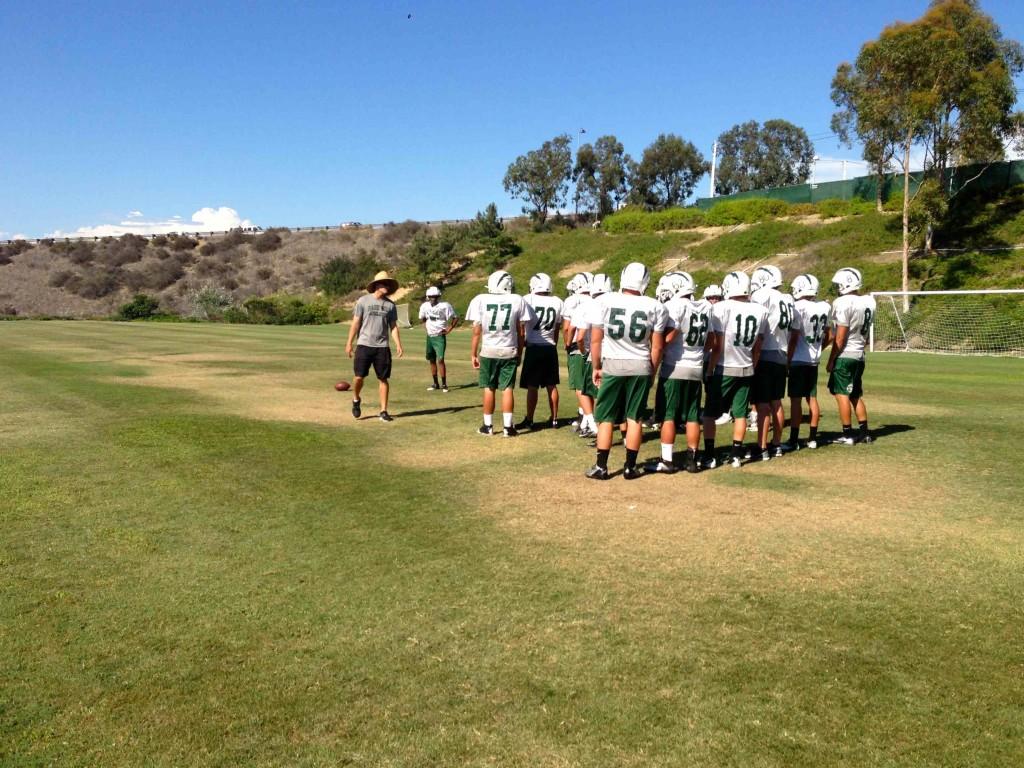 The varsity football team practices for its first home game. Photographer: Michelle Min