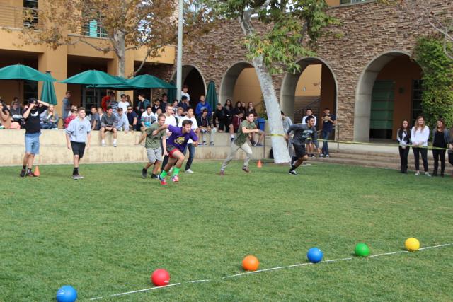 The seniors break loose and run after the start of the dodgeball game. 