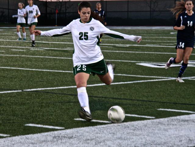 Senior Alexandra Mowrey kicks the soccer ball. March 3 2014. Photographer: Rebecca Lynskey.