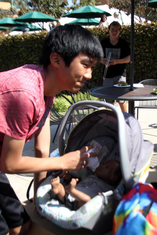 Junior Dan Lam tends to his baby. 