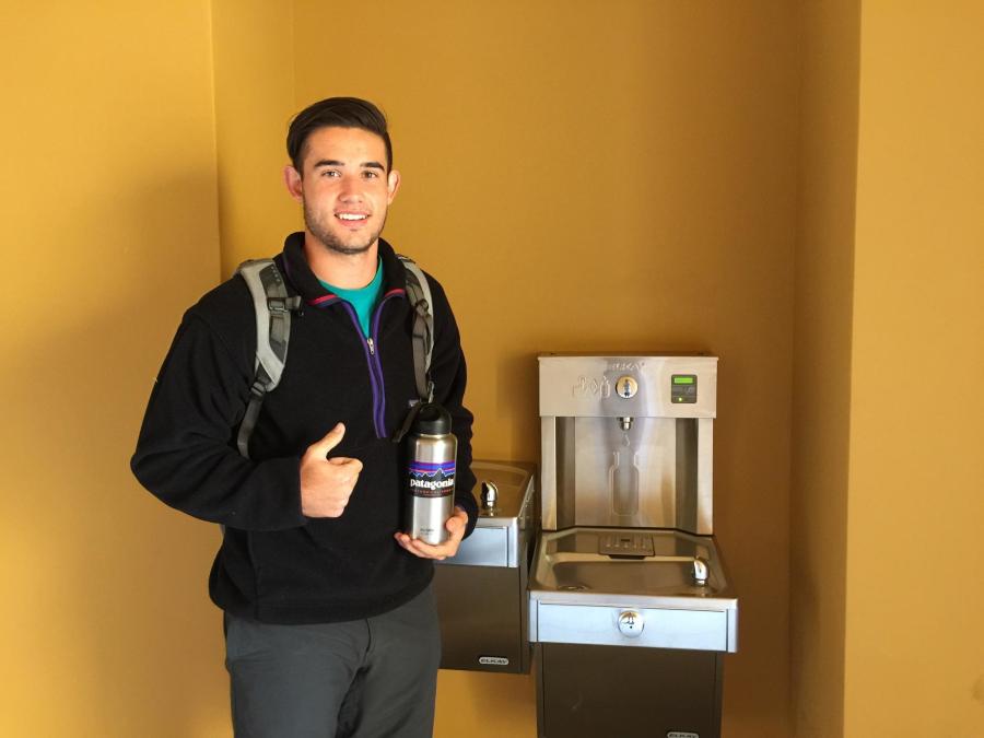 Parker Reposa stands next to one of the five new filtered water stations around campus.