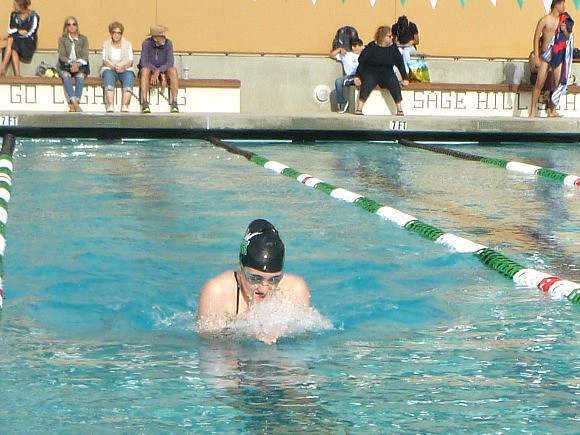 Nicole Harvey competes in a 100 yard breaststroke