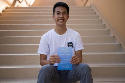 Senior Austin Lin holds up his newly published childrens book