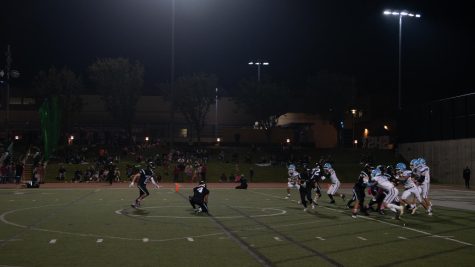 Juniors Danyel Khan (#2) and Jack Weisberg (#8) prepare a kickoff while their fellow Varsity Football teammates charge the opponents on their road to the CIF Championships.