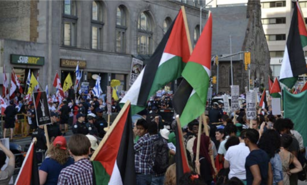 Counterprotests for opposing sides of the Israeli-Palestinian conflict square off on a street in Toronto, Ontario.