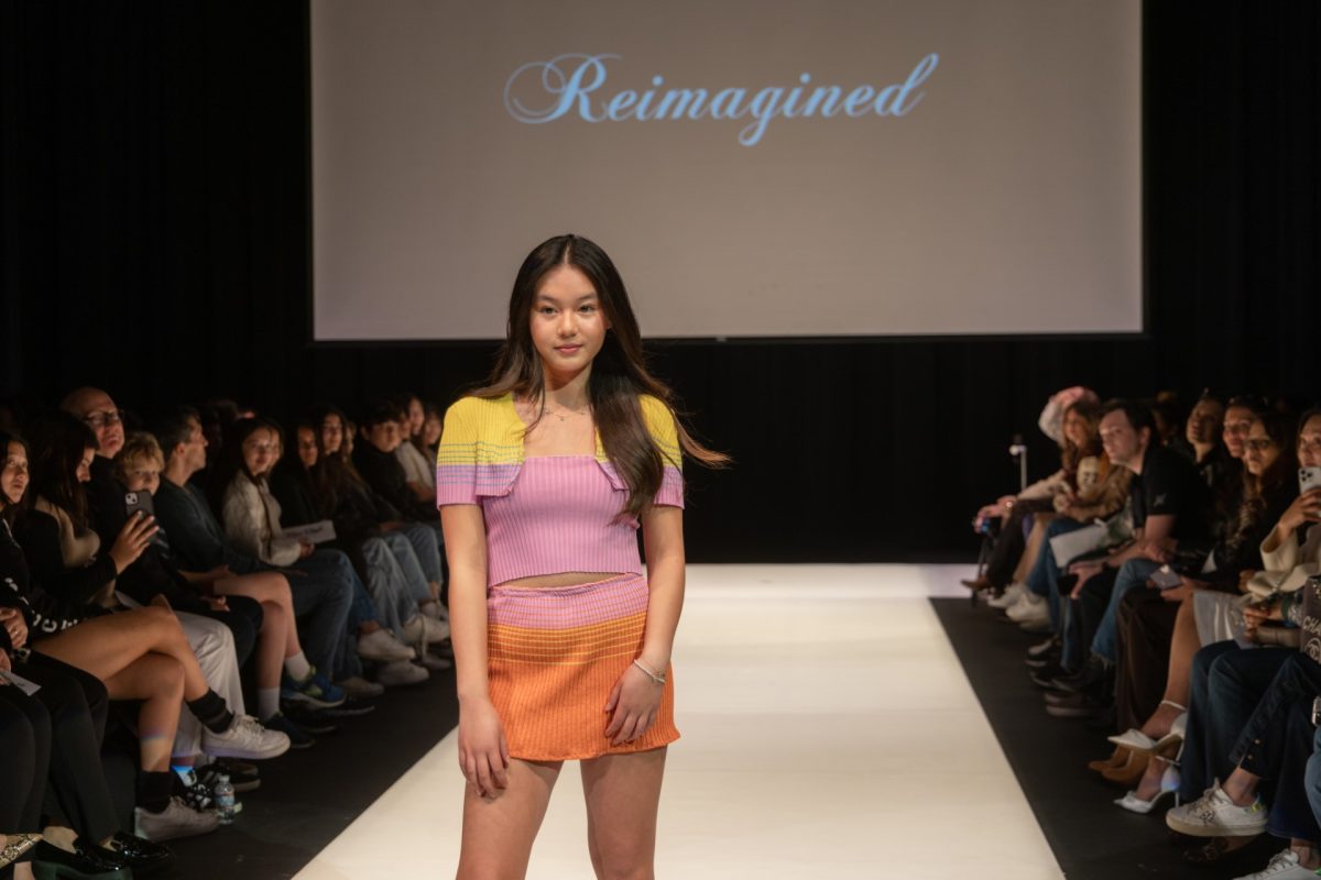 Freshman+Katie+Chang+modeling+a+Reimagined+piece+on+the+catwalk.+