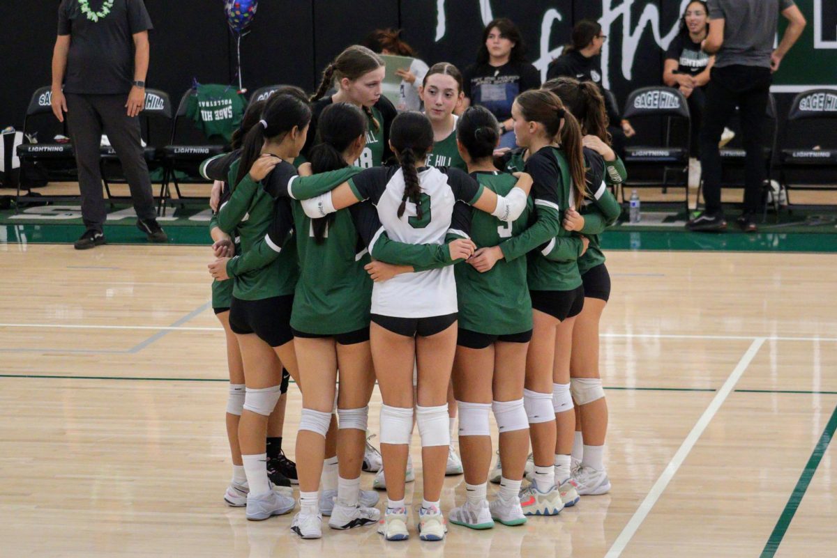 Varsity Girls’ Volleyball players encourage each other before a point on Sept. 18.
