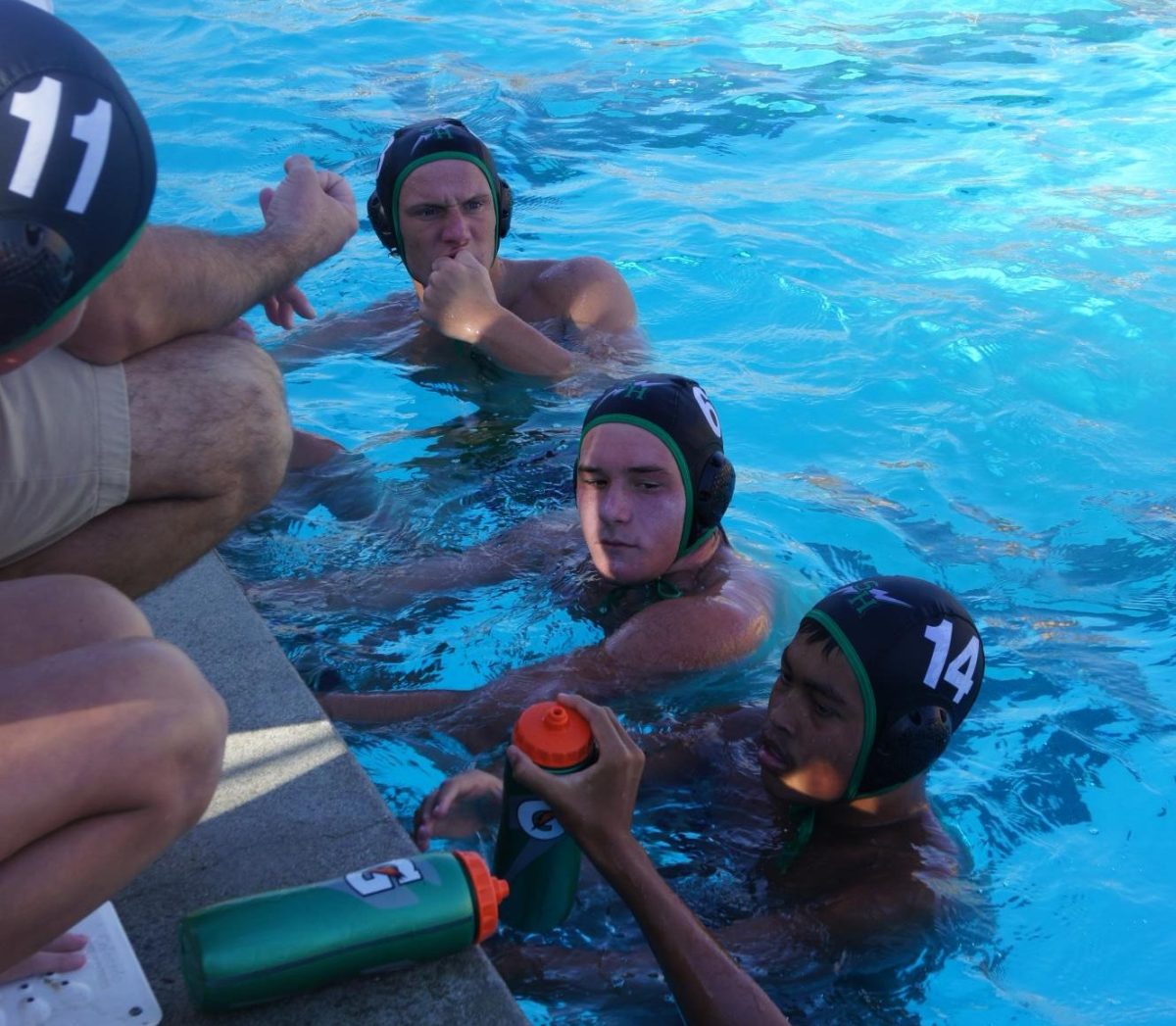 Senior Dylan Rosmann (6), Junior Luke Weichert (3), and Freshman Aaden Hobson (14) during a break before their next quarter on September 17, 2024.