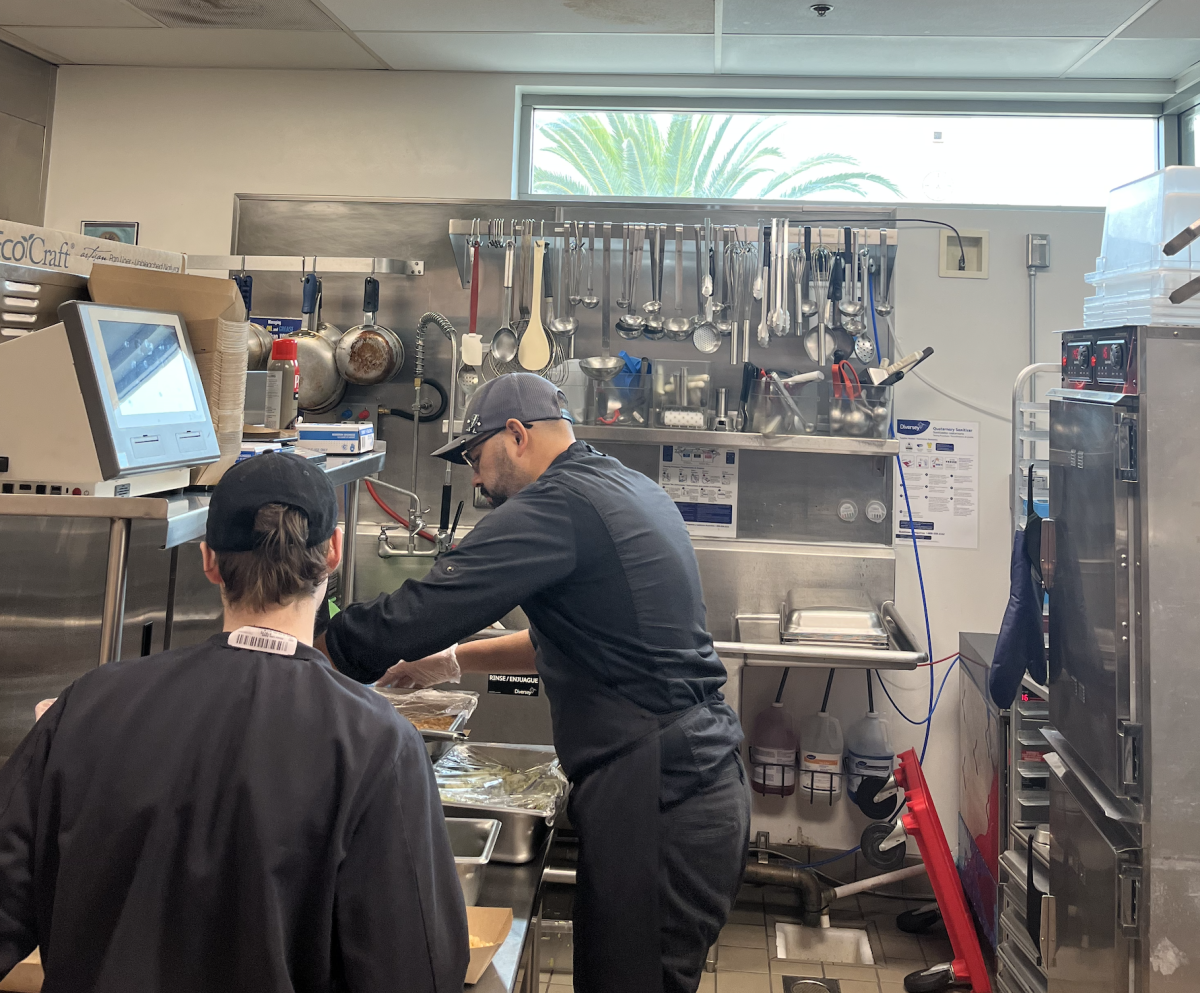 Chef Enrique cooks and serves food as lunch has started.