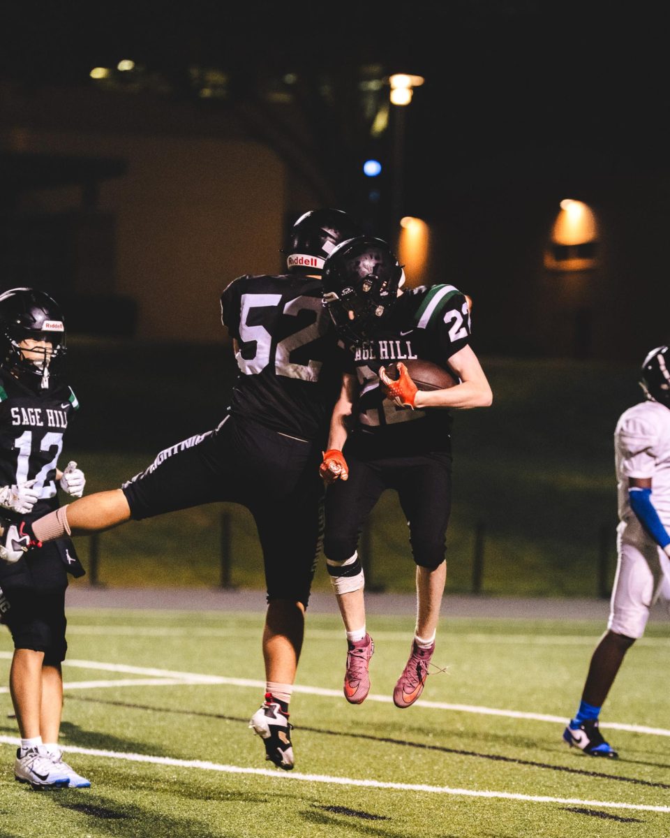 Sophomore JC Hoeppner (22) and freshman Daniel Peng (52) celebrate after a touchdown against Animo Robinson on Sept. 6.