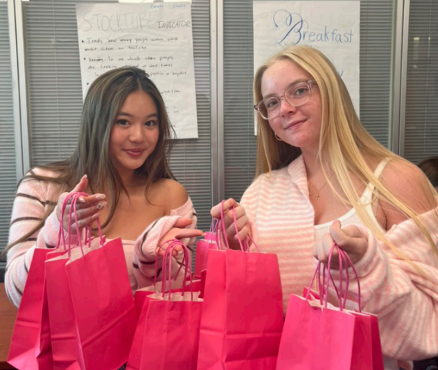 Junior founder and co-president Katie Chang and vice president Grace Joiner with finished hygiene care kits for survivors of domestic violence on Jan. 7.