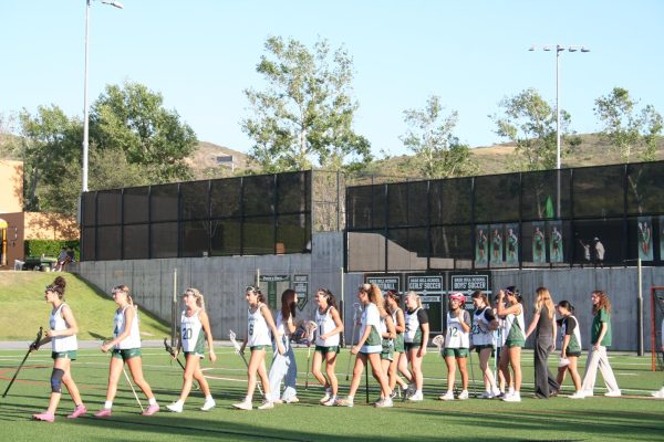 The girls’ lacrosse team lines up for the postgame handshake on April 8.
